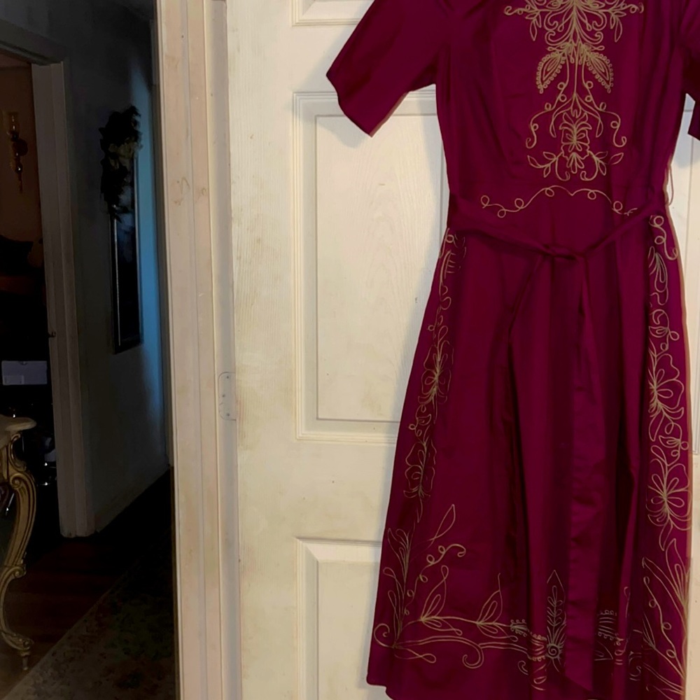 Burgundy with gold trimmings and sash
